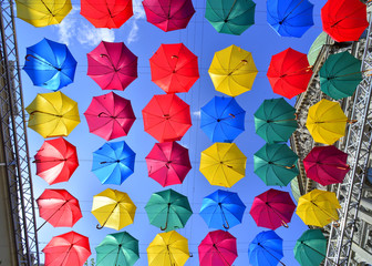 Fototapeta na wymiar Street decorated with colored umbrellas