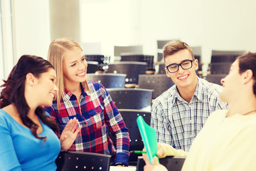 group of smiling students with notebook
