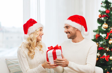 happy couple at home with christmas gift box