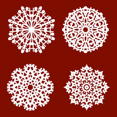 4 white isolated different snowflakes on a red background.