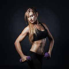 Sporty girl doing exercise with dumbbells, silhouette studio shot over white background