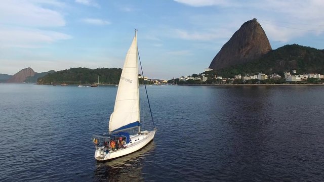 Sailboat Travel on Guanabara Bay with Sugarloaf Mountain background in Rio de Janeiro, Brazil.