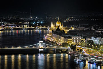 Budapest, Hungary. Night view of the Hungarian Parliament Building, Szechenyi Square (former Roosevelt Square), Szechenyi Chain Bridge and Margaret Bridge over Danube. View from the Gellert Hill.