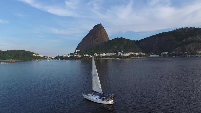 Sailboat Travel on Guanabara Bay with Sugarloaf Mountain background in Rio de Janeiro, Brazil.