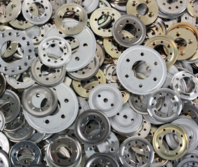 Pile of variety aluminum spacers washers, industrial background