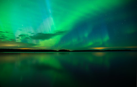 Northern lights over calm lake in Sweden (Aurora borealis)