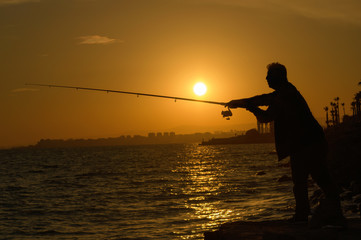 Silhouette of Fisherman at sunset