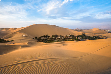 Fototapeta na wymiar Hucachina oasis in sand dunes near Ica, Peru
