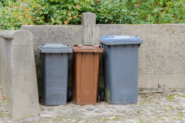 Drei Mülltonnen auf einem Hof