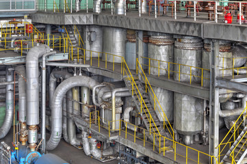 Machine room in thermal power plant with electric generators and turbines