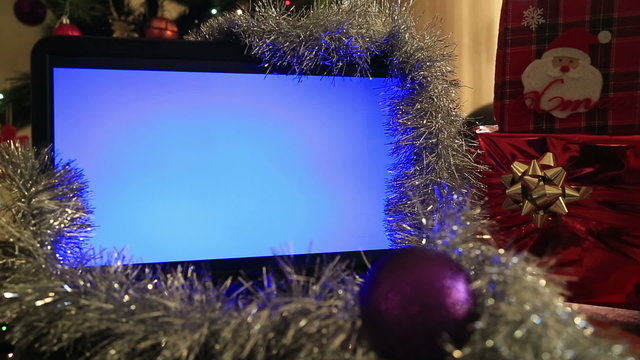 Chroma Key Laptop Monitor with gift box and christmas tree lights background