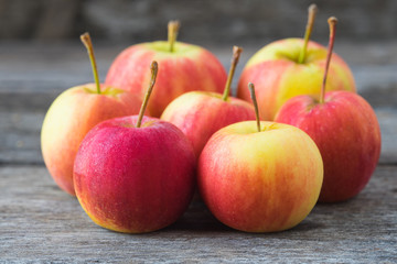 Apples on old wooden background.