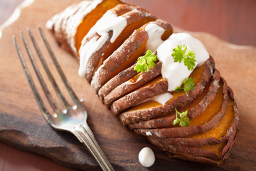 Baked hasselback potato with sour cream