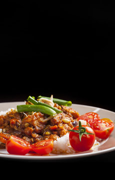 Szechuan chicken with white rice on a plate