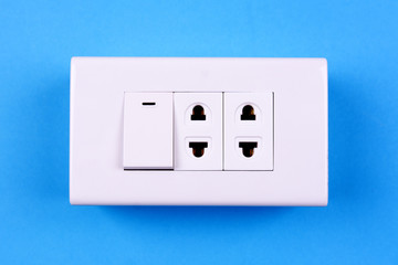 Electric light switch on blue background