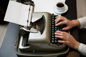 Hands writing on typewriter