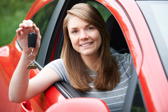Young Female Driver In Car Holding Keys