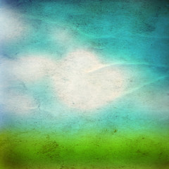 Conceptual green grass and sky old paper