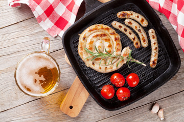 Grilled sausages and beer mug
