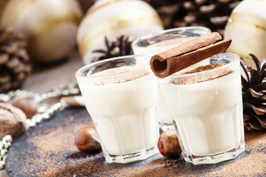 Eggnog with milk, cinnamon, grated nutmeg, decorated with fir co