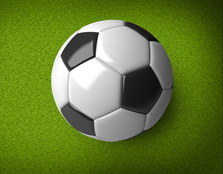 A realistic soccer ball isolated on a green background.
