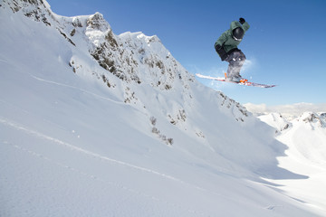 Fototapeta na wymiar Flying skier on mountains