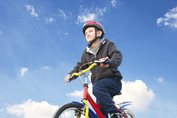 boy on the bike against the sky