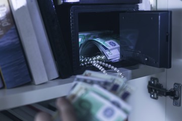 Burglar taking money and necklace