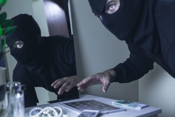 Robber in mask during burglary