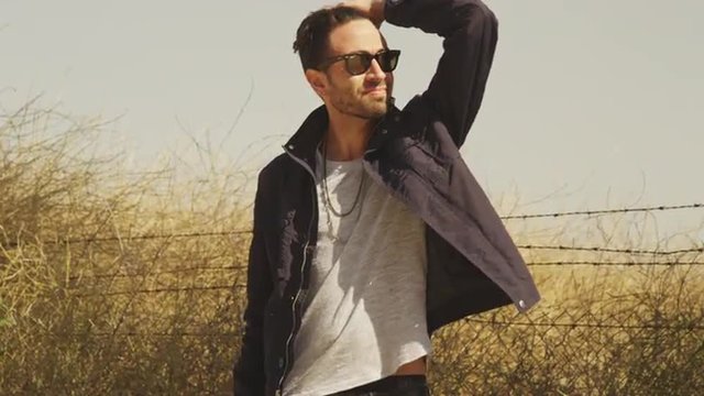 Sexy Hispanic hipster man smiling outdoors