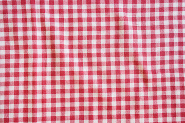 Red picnic tablecloth background, checkered fabric.