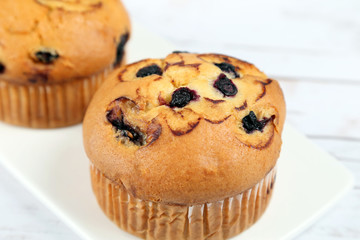 Blueberries muffins on wooden background
