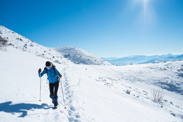 Fototapeta na wymiar Girl walking on snowy mountains