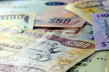 Naklejka premium Assorted Jamaican money banknotes - Financial security concept background
