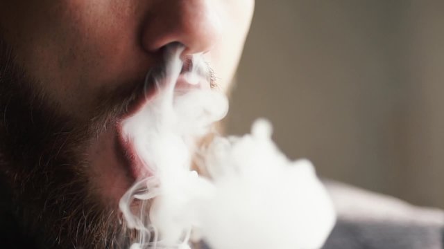 Man Exhaling smoke from a vaporizer shot in slow motion