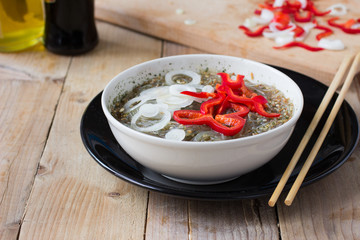 Cooked Cellophane noodles in a bowl with traditional chinese wooden chopsticks
