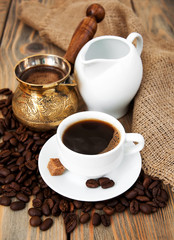 coffee cup with coffee beans, milk jug and turk