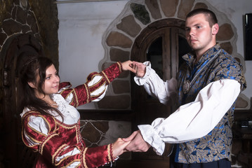 Attractive couple in retro dresses dance
