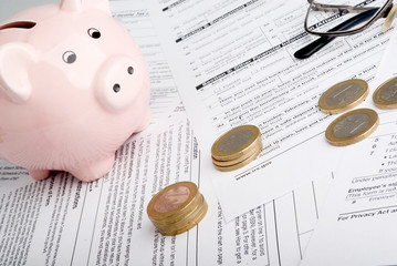 Fototapeta na wymiar Tax form business financial concept - individual return tax form with money, glasses and piggy bank