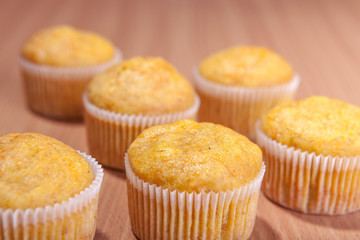 Six cupcakes on wood texture table