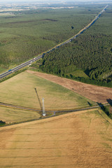 aerial view of  the highway and forests with harvest fields in s