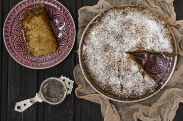 Apple charlotte with semolina topped with powdered sugar   