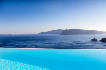 Naklejka na ściany i meble Infinity pool on the rooftop with the ocean in Santorini Island,