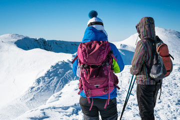 girls walking on snowy mountains