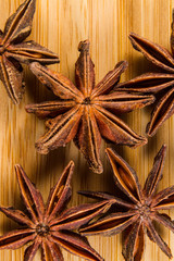 Star Anise, Illicium verum on a wood background. Close up.