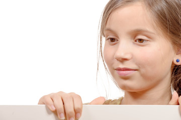 Beautiful young girl with a blank poster isolated  on white back