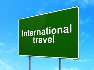 Vacation concept: International Travel on road sign background