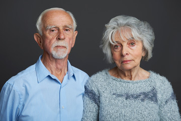 Studio Portrait Of Serious Senior Couple