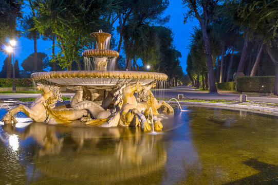 Old marble stone fountain in a dark evening park