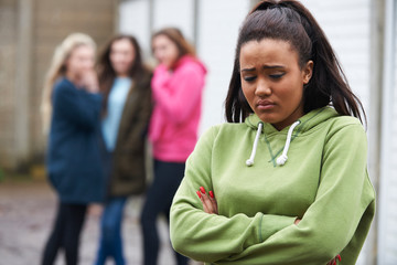 Unhappy Teenage Girl Being Talked About By Peers